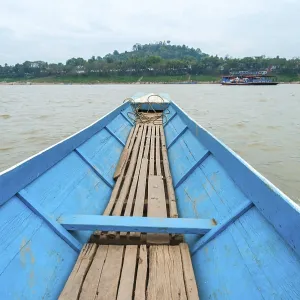 Crossing Mekong river by boat in Luang Prabang