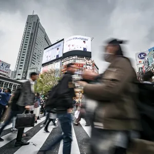 Crowd crossing zebra crossing on a large intersection