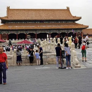 Crowds explore a historic temple complex with richly decorated architecture Crowds explore a historic temple complex with richly decorated architecture