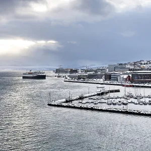 The cruise ship Havila Pollux enters the harbour of Tromso in the evening