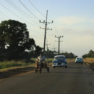 Cuban Highway Scene with old cars and electric wires