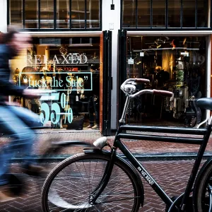 Cyclist rides through shopping street