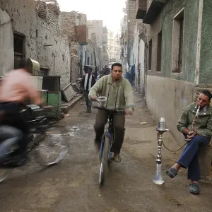 Cyclists and an Egyptian man smoking a water pipe Cyclists and an Egyptian man smoking a water pipe