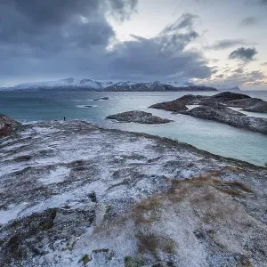 Dark clouds over the sea, coastal landscape in winter Dark clouds over the sea, coastal landscape in winter