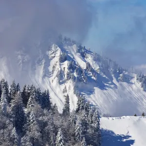 Deeply snow-covered winter landscape with a view of the Faistenau Schafberg
