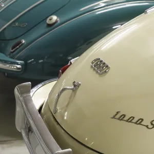 Detailed view of two Audi classic cars in cream and blue with chrome bumpers