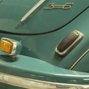 Detailed view of a blue vintage car with chrome accents and tail light
