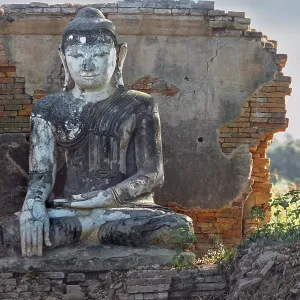 Dilapidated temple wall with Buddha figure in Amarapura