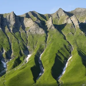 Distinctive rocky ridges with green vegetation under clear