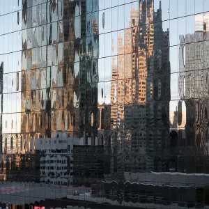 Distorted reflections of buildings on a glass facade in warm morning light in Toronto Distorted reflections of buildings on a glass facade in warm morning light in Toronto