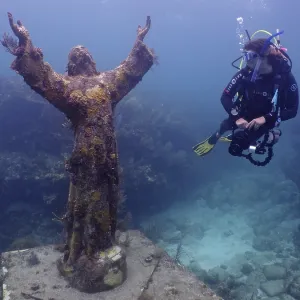 Diver looking at the statue of Jesus Christ underwater (Christ of the Abyss)