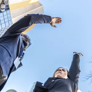 Diverse business professionals extending arms upwards