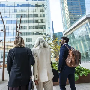 Diverse group of business people walking through a modern urban city district
