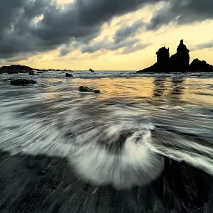 Dramatic cloud atmosphere with rock formation at sunset on the beach of Playa de Benijo Dramatic cloud atmosphere with rock formation at sunset on the beach of Playa de Benijo