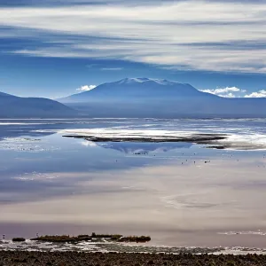 Dramatic cloud formations over a reflecting lake and distant mountain ranges