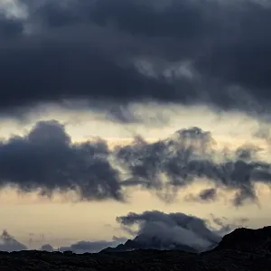 Dramatic clouds over Engadine mountains at blue hour Dramatic clouds over Engadine mountains at blue hour