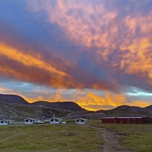 Dramatic sunset over small cabins at a campsite Dramatic sunset over small cabins at a campsite