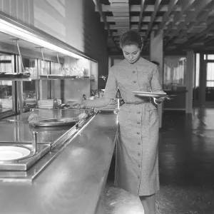 She dressed nicely 1956. The young model is helping herself to the food at the restaurant