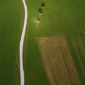 Drone shot, agricultural landscape with country road from above