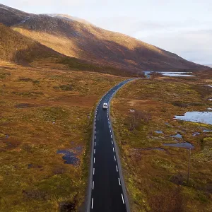 Drone shot, campervan on a road with autumnal vegetation Drone shot, campervan on a road with autumnal vegetation