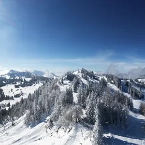 Drone shot, deep snowy winter landscape in the Osterhorn group with view to Pillstein