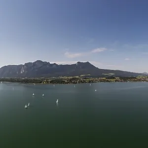 Drone shot, sailing boats at Mondsee with Schafberg Drachenwand and Schober