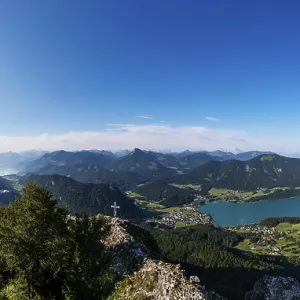 Drone shot, summit cross on the Frauenkopf with a view of Lake Fuschl Drone shot, summit cross on the Frauenkopf with a view of Lake Fuschl