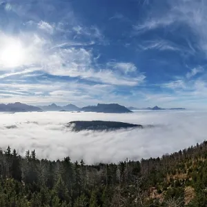 Drone shot, view from Schwarzenberg to a sea of fog in the Salzach valley