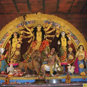 Durga clay model killing demon mahishasura with statues of kartikeya ganesha and lakshmi saraswati on Durga puja