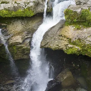 Dynamic waterfall flowing through a rocky gorge Dynamic waterfall flowing through a rocky gorge