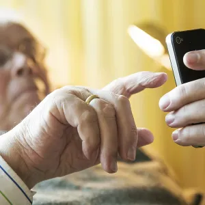 Elderly man working on his smartphone Elderly man working on his smartphone