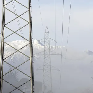 Electricity pylon with snow-capped mountain in Switzerland Electricity pylon with snow-capped mountain in Switzerland