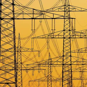 Electricity pylons of a power line at sunset