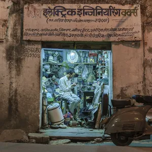 Electronics retailer in his workshop in the evening