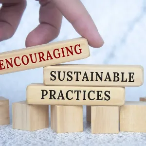 Encouraging sustainable practices text on wooden blocks