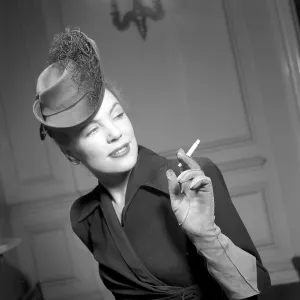 England 1945. A fashionable young woman wearing a creative hat and decoration