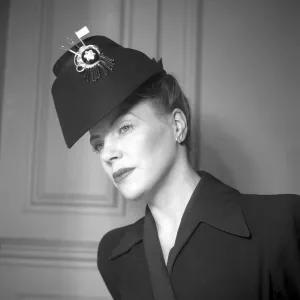 England 1945. A fashionable young woman wearing a creative hat and decoration