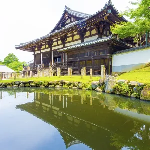 Front entrance of Sangatsu-do Hall reflected in the front pond on a sunny morning in the Todai-ji temple complex