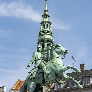 Equestrian statue of Absalon and the tower of St Nicholas Church on the central square Hojbro Plads in Copenhagen Equestrian statue of Absalon and the tower of St Nicholas Church on the central square Hojbro Plads in Copenhagen