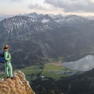 Evening atmosphere, mountaineer at the summit of Schartschrofen looking down on Haldensee Evening atmosphere, mountaineer at the summit of Schartschrofen looking down on Haldensee