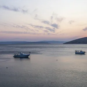 Evening mood at the sea, boats in a bay Evening mood at the sea, boats in a bay