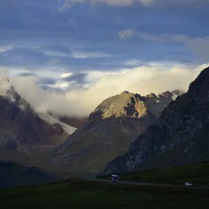 Evening sun on the mountains above the winding mountain road Evening sun on the mountains above the winding mountain road