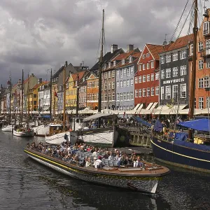 Excursion boat at the busy Nyhavn Canal Excursion boat at the busy Nyhavn Canal