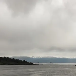 Expansive water view with cloudy skies and faint mountain outline in Nanaimo Expansive water view with cloudy skies and faint mountain outline in Nanaimo