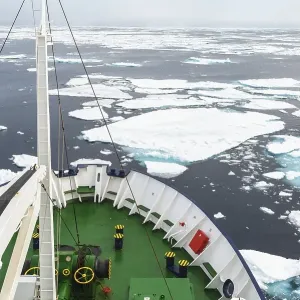 Expedition Boat navigating through melting pack ice Expedition Boat navigating through melting pack ice