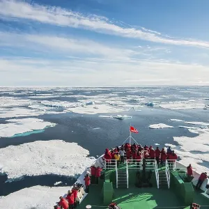 Expedition ship navigating through the pack ice in the Arctic