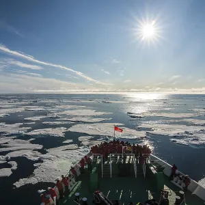 Expedition ship navigating through the pack ice in the Arctic