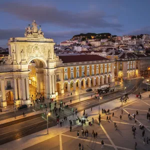 Experience the magic of Christmas in Lisbon as Praca do Comercio glows with festive lights in the evening twilight