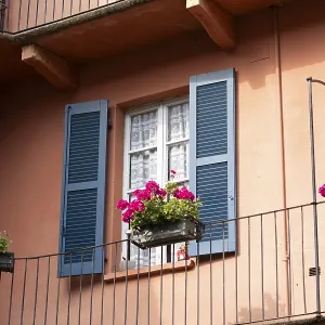 Exploring the architectural beauty colorful buildings and the charming window design with blue shutters Exploring the architectural beauty colorful buildings and the charming window design with blue shutters
