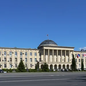 Extensive classical building in panoramic view under bright blue sky